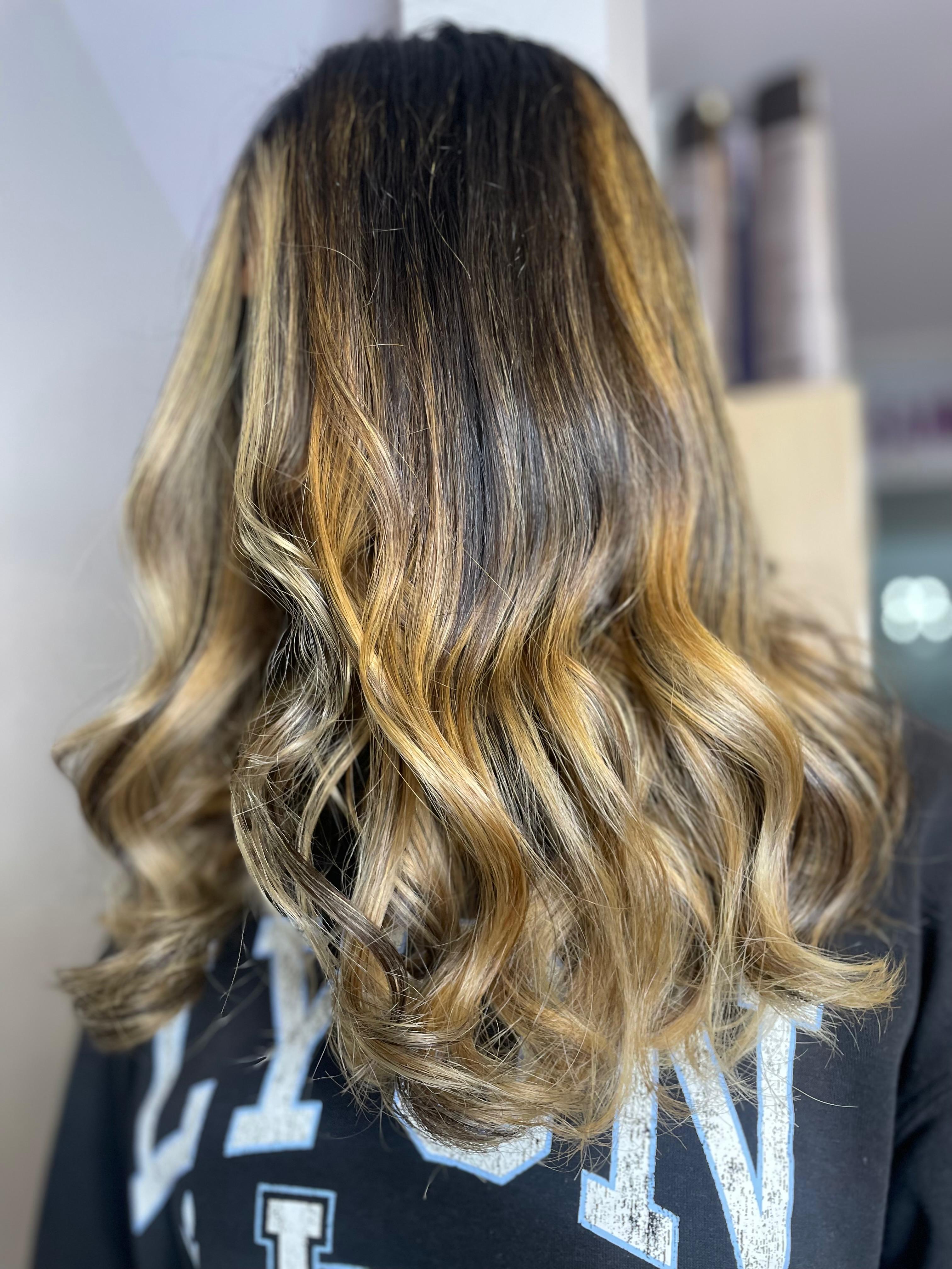 Golden-blonde highlights on long straight hair