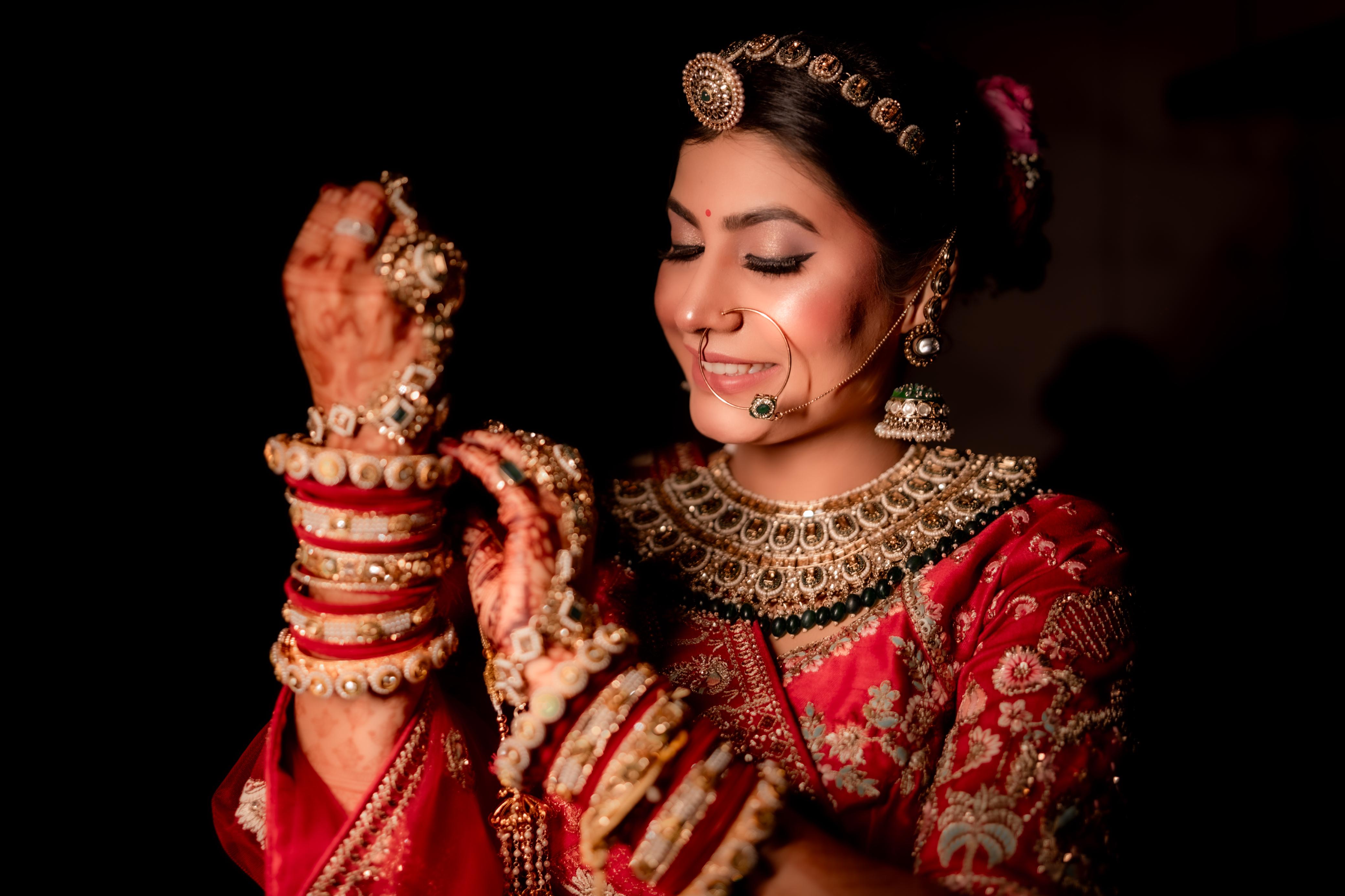 Bride with mehndi hands and gold bangles