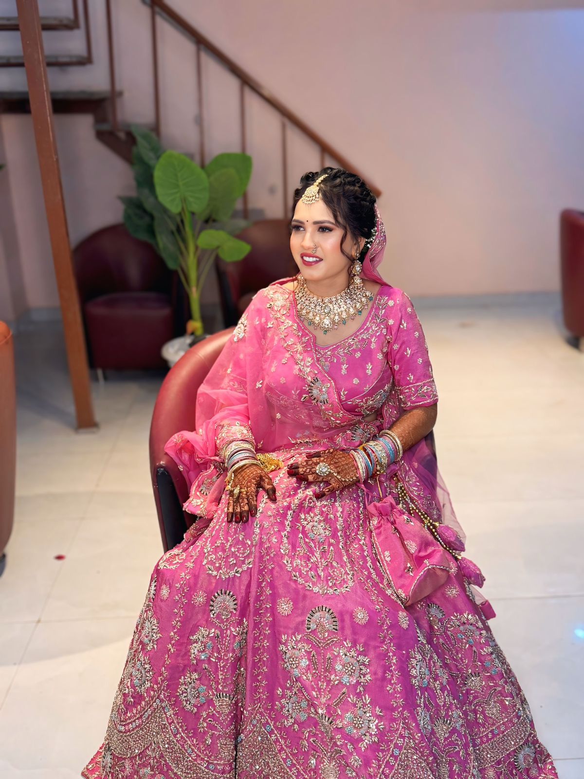 Bride in pink lehenga with gold jewellery