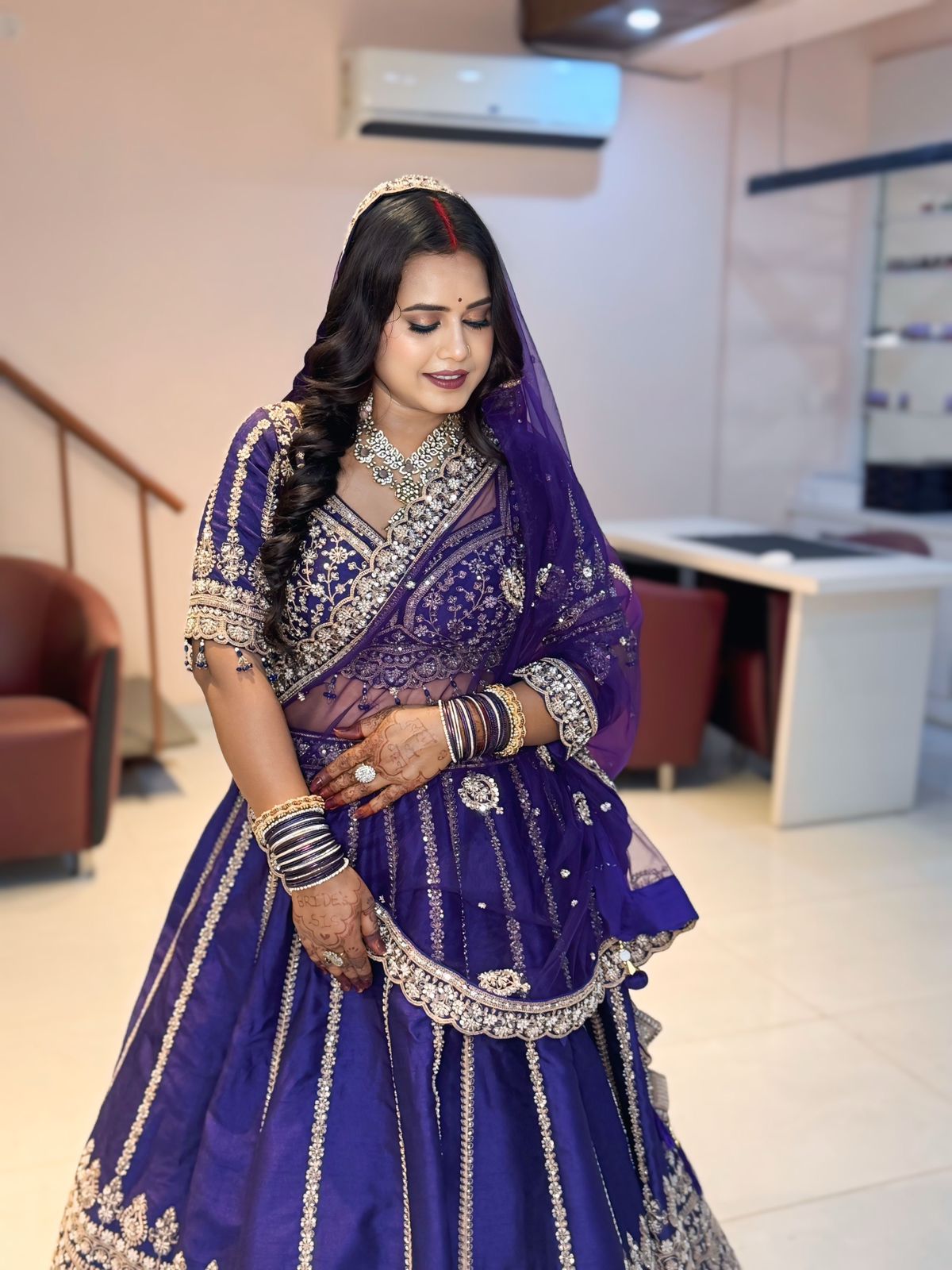Bride in purple lehenga with silver necklace