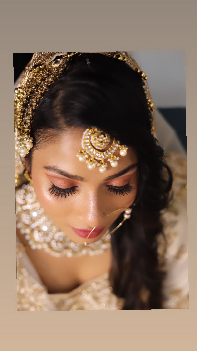 Close-up bridal makeup with maang tikka and nath
