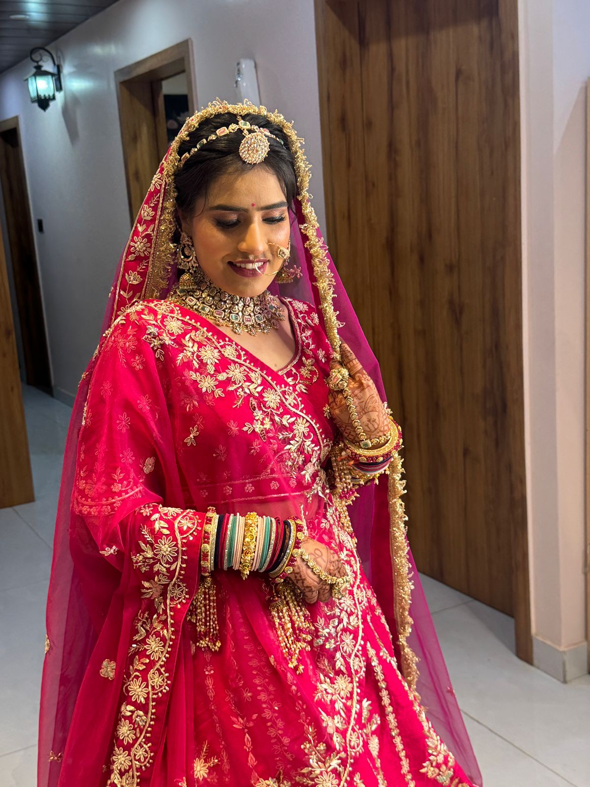 Artist applying lip colour to bride